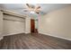 Comfortable bedroom with wood floors, a ceiling fan, and a closet with space for storage at 4040 E Fort King St, Ocala, FL 34470