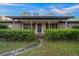 The inviting entrance features a covered porch framed by manicured greenery at 4040 E Fort King St, Ocala, FL 34470