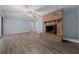 Spacious living room with a brick fireplace and natural light at 4040 E Fort King St, Ocala, FL 34470
