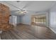 Spacious living room features a brick fireplace and sliding glass doors leading to an enclosed patio and pool at 4040 E Fort King St, Ocala, FL 34470