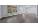 Spacious living room with wood-look floors and large windows for natural light at 4040 E Fort King St, Ocala, FL 34470