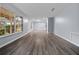 Bright living room features gray walls, wood-look floors, and large windows at 4040 E Fort King St, Ocala, FL 34470