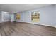 Bright living room featuring gray walls and wood-look floors at 4040 E Fort King St, Ocala, FL 34470