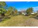 Backyard featuring palm trees and a screened-in lanai at 10055 Sw 90Th Loop, Ocala, FL 34481
