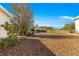 Backyard featuring a treed area with a house and a screened-in lanai in the background at 10055 Sw 90Th Loop, Ocala, FL 34481