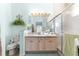 Well-lit bathroom with double sinks, tile floors, and a shower at 10055 Sw 90Th Loop, Ocala, FL 34481