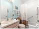 Neutral-toned bathroom featuring a shower and a light blue accent wall at 10055 Sw 90Th Loop, Ocala, FL 34481