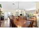 Open-concept dining area offering a large wooden table and views of the living room at 10055 Sw 90Th Loop, Ocala, FL 34481