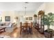 Formal dining area featuring a large wood table, display cabinet, and decorative accents at 10055 Sw 90Th Loop, Ocala, FL 34481