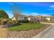 Home exterior featuring well-maintained landscaping and an attached garage at 10055 Sw 90Th Loop, Ocala, FL 34481