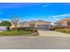 Charming single-story home with a well-maintained lawn, mature landscaping, and a two-car garage at 10055 Sw 90Th Loop, Ocala, FL 34481