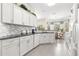 Bright, all-white kitchen features modern appliances and stylish granite countertops at 10055 Sw 90Th Loop, Ocala, FL 34481