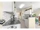 Modern kitchen with white cabinets, tile backsplash, granite counters, and breakfast bar area at 10055 Sw 90Th Loop, Ocala, FL 34481