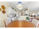 Bright kitchen and breakfast nook with tiled floors, white cabinets and direct access to living room at 10055 Sw 90Th Loop, Ocala, FL 34481