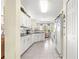 Bright, all-white kitchen features modern appliances, granite countertops and charming breakfast nook at 10055 Sw 90Th Loop, Ocala, FL 34481