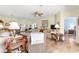 Spacious living room features hardwood floors, ceiling fan, neutral paint and comfortable seating at 10055 Sw 90Th Loop, Ocala, FL 34481