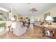 Spacious living room with hardwood floors, plenty of sunlight, and an inviting atmosphere for gathering and relaxing at 10055 Sw 90Th Loop, Ocala, FL 34481