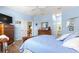 Comfortable primary bedroom with a traditional dresser, hardwood floors, and an ensuite at 10055 Sw 90Th Loop, Ocala, FL 34481