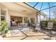 Relaxing screened patio provides comfortable seating, dining, and direct access to the house at 10055 Sw 90Th Loop, Ocala, FL 34481