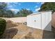 Well-maintained backyard with gravel, stepping stones, and a storage shed at 1019 Avalon Ave, Lady Lake, FL 32159