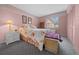 Comfortable bedroom with pink walls, carpet flooring, and ample closet space for storage at 1019 Avalon Ave, Lady Lake, FL 32159
