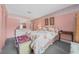 Bright bedroom featuring a floral-patterned bedspread, matching decor, and a cozy atmosphere at 1019 Avalon Ave, Lady Lake, FL 32159