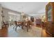 Dining area with wood floors, seating for four, and natural light at 1019 Avalon Ave, Lady Lake, FL 32159