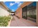 Side yard featuring a stone walkway and manicured landscaping and house exterior with a light peach color at 1019 Avalon Ave, Lady Lake, FL 32159