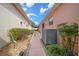 Side yard featuring a stone walkway and manicured landscaping and house exterior with a light peach color at 1019 Avalon Ave, Lady Lake, FL 32159