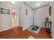 Hallway with hardwood floors and decorative wallpaper leading to other rooms at 1019 Avalon Ave, Lady Lake, FL 32159