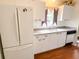 Kitchen features white appliances, wood floors, and an under-mount sink at 1019 Avalon Ave, Lady Lake, FL 32159