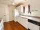 Cozy kitchen with white appliances, laminate countertops, and brown cabinetry at 1019 Avalon Ave, Lady Lake, FL 32159