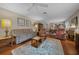 Spacious living room with hardwood floors, vintage furniture, and an open layout at 1019 Avalon Ave, Lady Lake, FL 32159