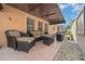 Covered patio with comfortable wicker seating and well-maintained landscaping at 1019 Avalon Ave, Lady Lake, FL 32159