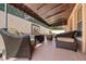 Covered patio with comfortable wicker seating and a decorative nautical sculpture at 1019 Avalon Ave, Lady Lake, FL 32159