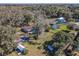 An aerial view showcases the house and its proximity to mature trees and neighborhood homes at 10376 Se 43Rd Ct, Belleview, FL 34420