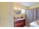 Bathroom featuring a granite sink, a mirror, and a shower with curtains at 10376 Se 43Rd Ct, Belleview, FL 34420