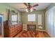Spacious bedroom with a vintage dresser and a large window at 10376 Se 43Rd Ct, Belleview, FL 34420