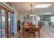 Dining room with natural light, laminate floors, table, and sliding glass doors at 10376 Se 43Rd Ct, Belleview, FL 34420
