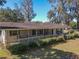 Charming front porch with ample space, offering a relaxing outdoor view at 10376 Se 43Rd Ct, Belleview, FL 34420