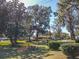 Beautiful front yard view with mature trees and well-maintained landscaping at 10376 Se 43Rd Ct, Belleview, FL 34420
