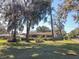Charming home with mature trees, landscaping, and a well-manicured front yard at 10376 Se 43Rd Ct, Belleview, FL 34420