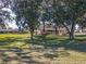 Beautiful front yard view with mature trees and well-maintained landscaping at 10376 Se 43Rd Ct, Belleview, FL 34420