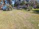 Spacious front yard with mature trees and landscaping offering a serene setting at 10376 Se 43Rd Ct, Belleview, FL 34420