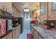 Functional kitchen featuring tile countertops, updated appliances, and ample cabinet space at 10376 Se 43Rd Ct, Belleview, FL 34420