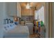 Functional laundry room with a washing machine, dryer, storage cabinets, and a window for natural light at 10376 Se 43Rd Ct, Belleview, FL 34420
