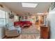 Cozy living room with laminate floors, ceiling fan, and comfortable furnishings at 10376 Se 43Rd Ct, Belleview, FL 34420