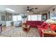 Living room with a ceiling fan, cozy seating, natural light, and laminate flooring at 10376 Se 43Rd Ct, Belleview, FL 34420