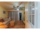 Bright living room with a ceiling fan, curtains, and a woven coffee table at 10376 Se 43Rd Ct, Belleview, FL 34420