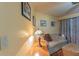 Comfortable living room featuring a couch, decorative pillows, and a vintage-style lamp at 10376 Se 43Rd Ct, Belleview, FL 34420